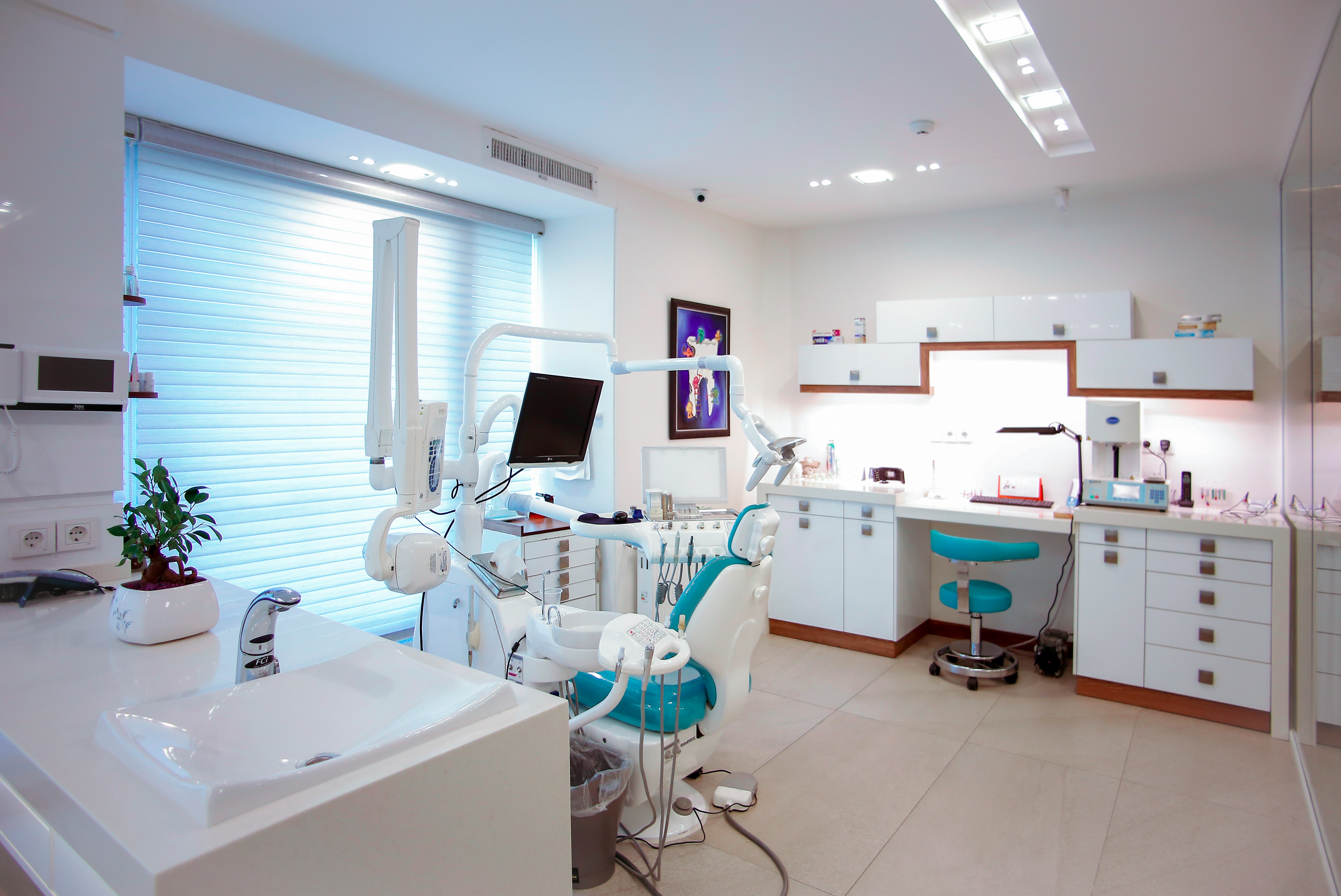 Dental team working together with a patient in a modern UK dental practice